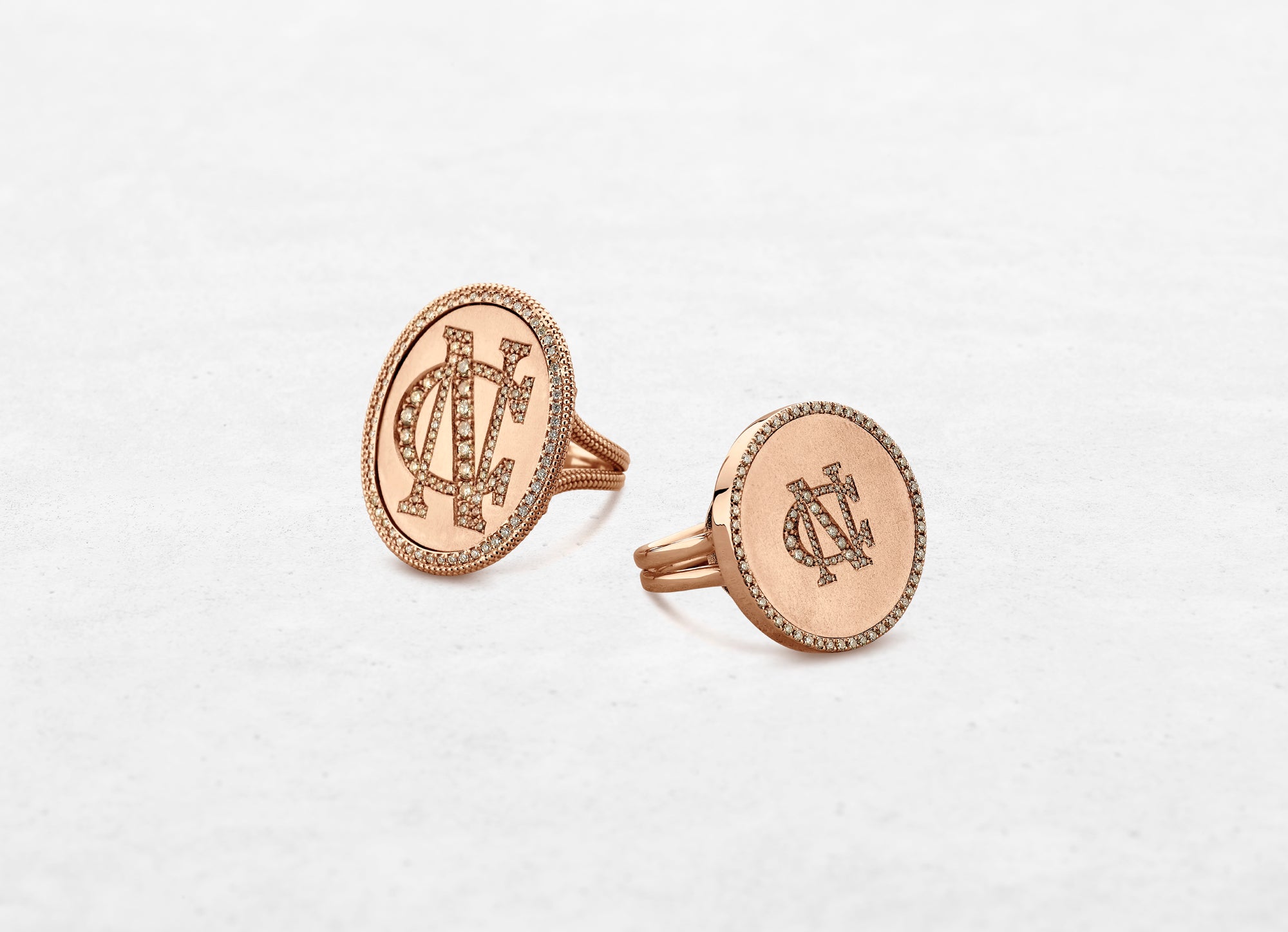 two rose gold rings with custom initials set in diamonds made by O! Jewelry