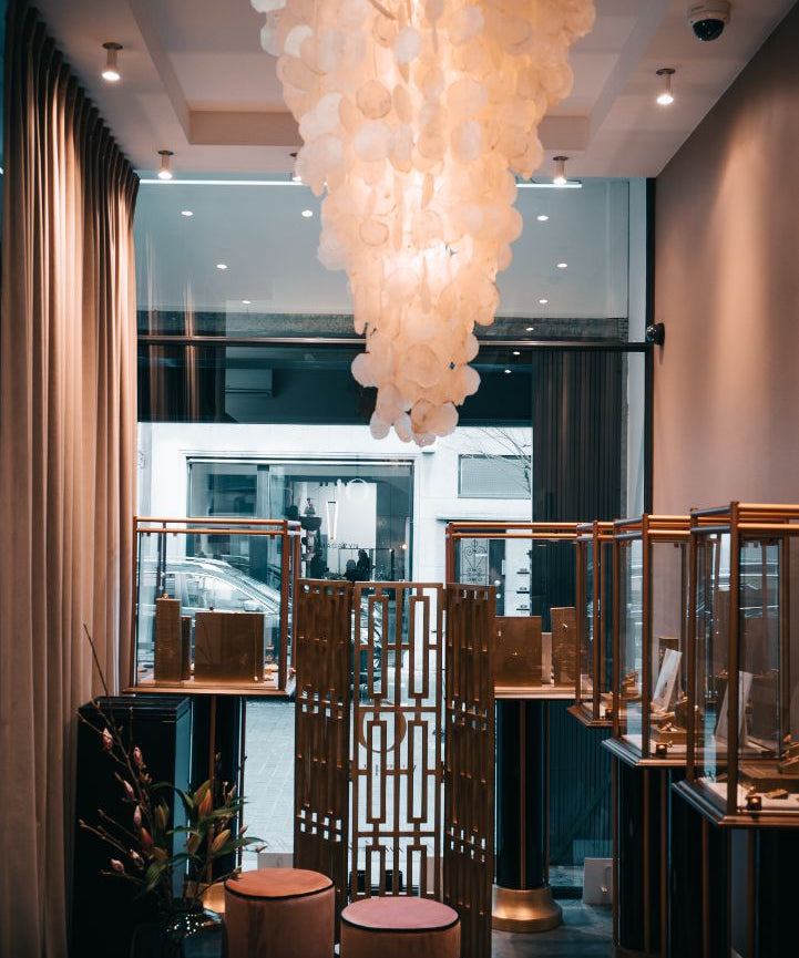 interior of the boutique of O! Jewelry in Antwerp with a lamp hanging on the ceiling surrounded by jewelry displays