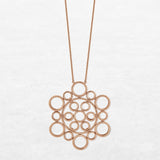 Necklace with different circular shapes in different sizes in rose gold made by O! Jewelry