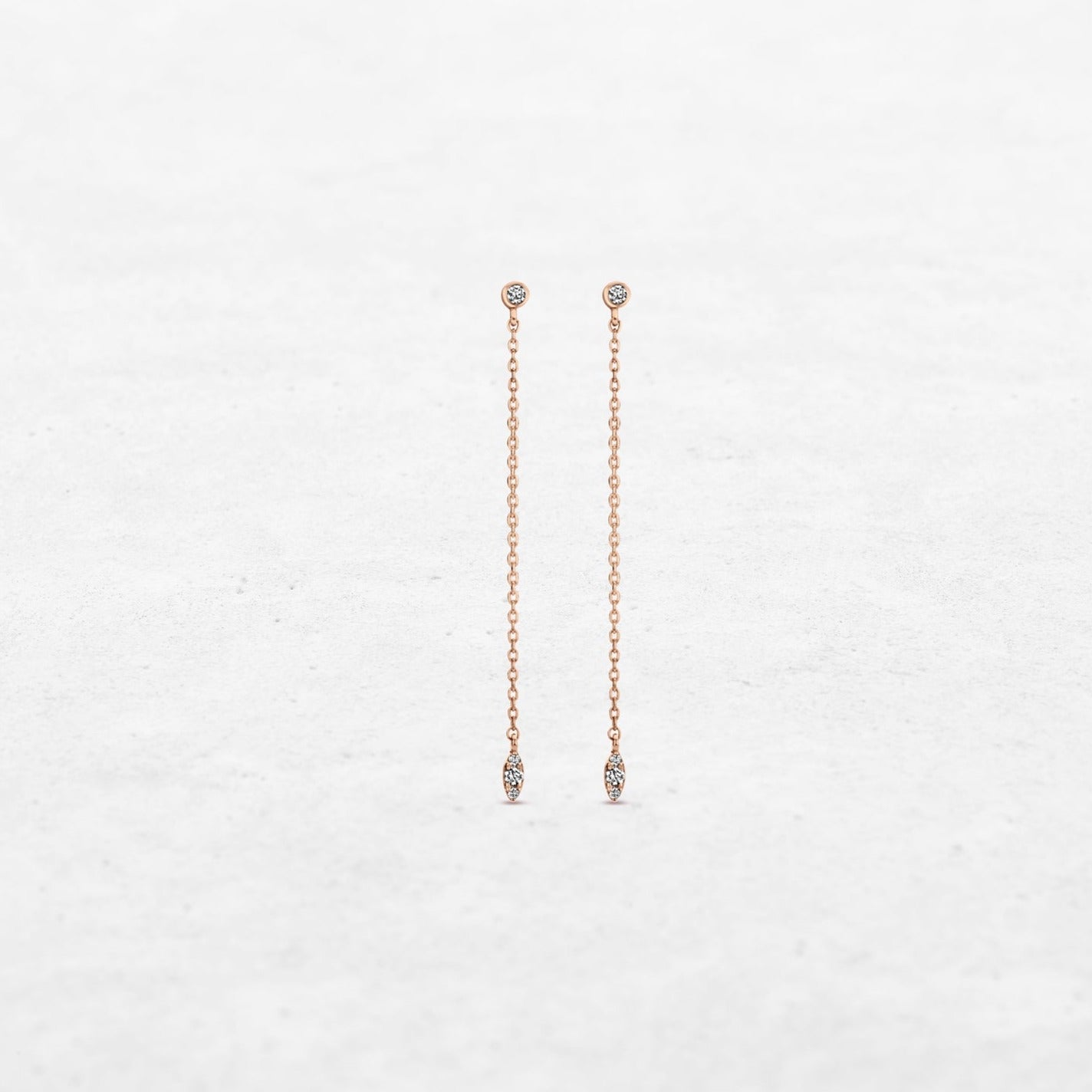 Single diamond leaf earrings hanging on chain in rose gold made by O! Jewelry
