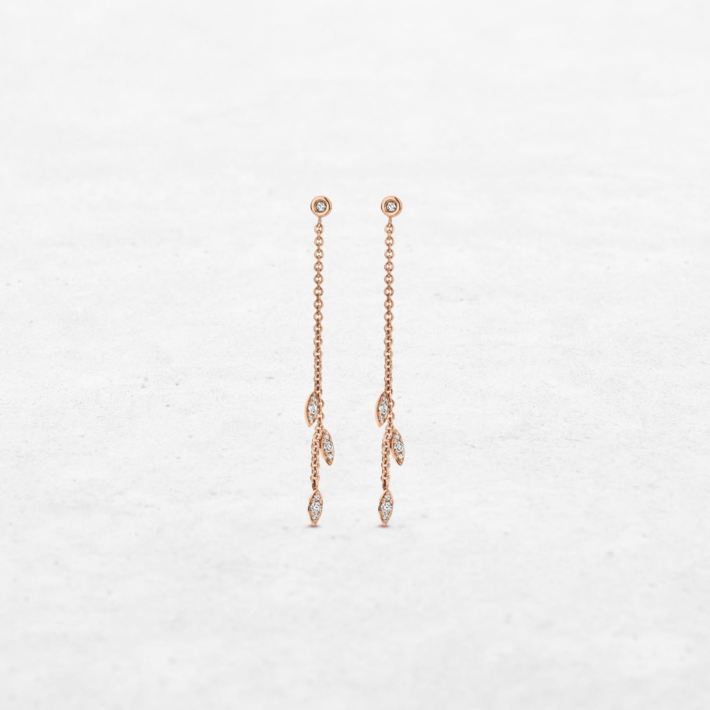 Triple diamond leaf earrings hanging on chain in rose gold made by O! Jewelry