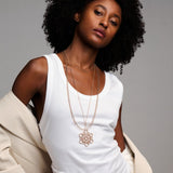 model wearing circular necklace together with chains in rose gold made by O! Jewelry