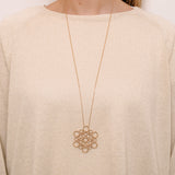 Low-hanging circular necklace around neck by O! Jewelry