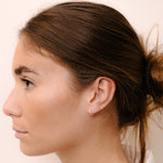 Model wearing hoop earring by O! Jewelry on one side